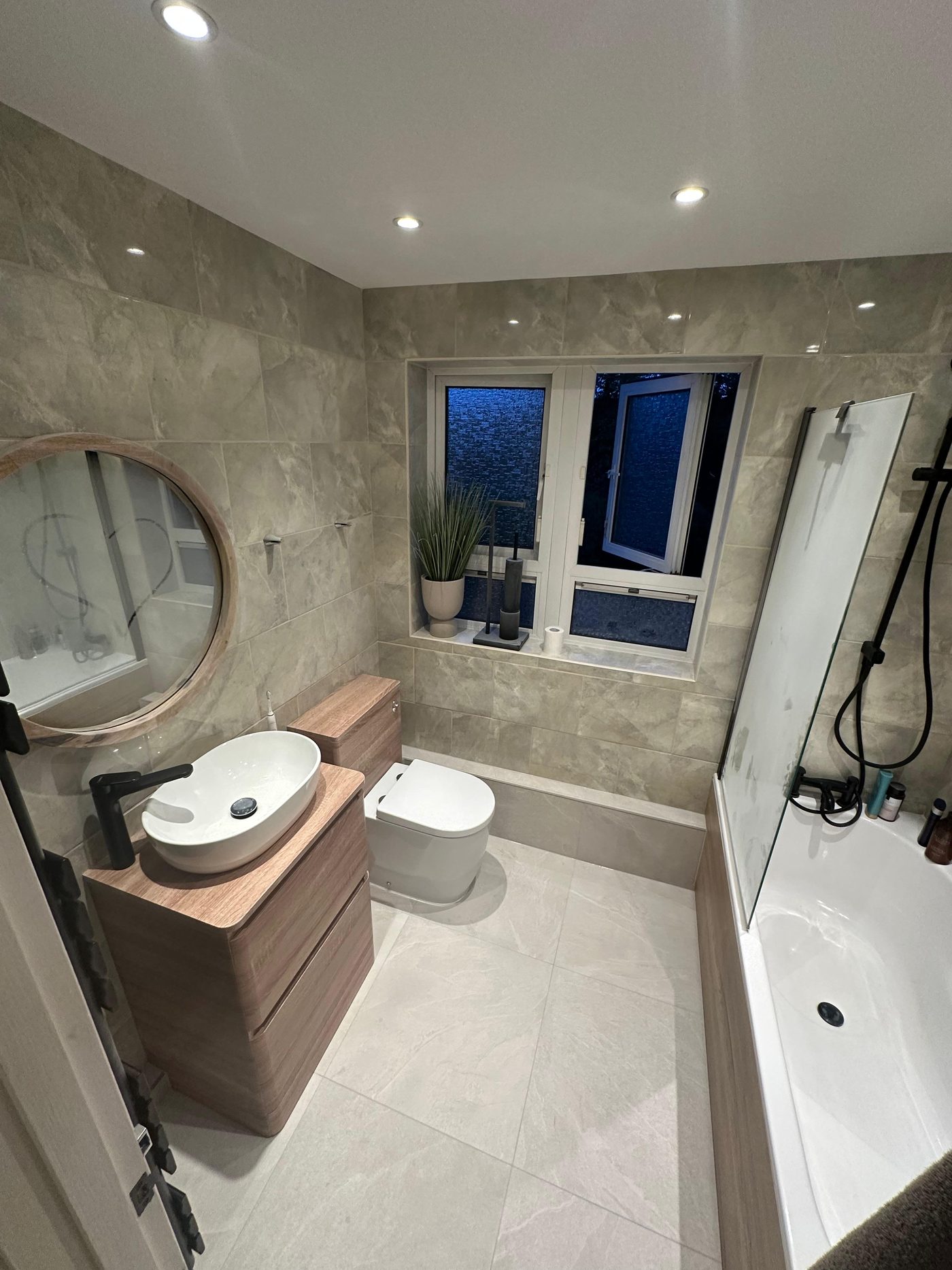 Bathroom with newly laid floor tiling, fitted vanity unit, basin, WC and bath panel, Richmond