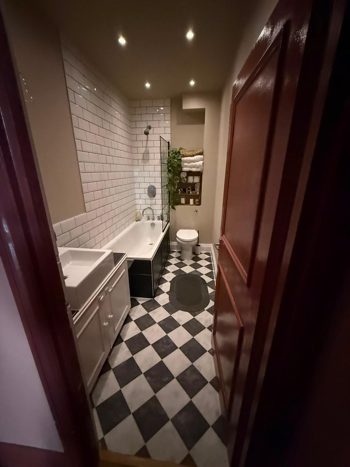 Bathroom with newly fitted bath panel, vinyl flooring and freshly painted walls and door, Shepherd's Bush